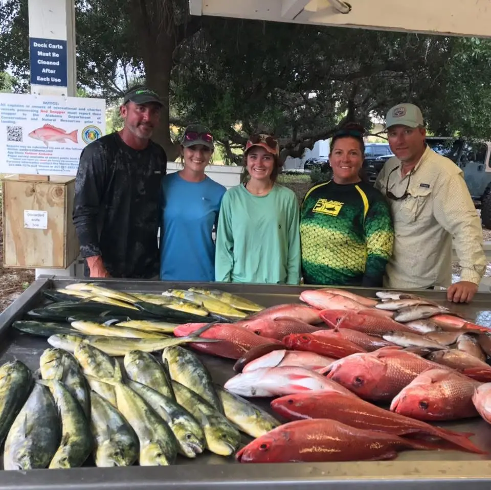 Group displaying a full table of fish after a 10-hour bottom fishing trip on Deep South Charters Orange Beach Alabama