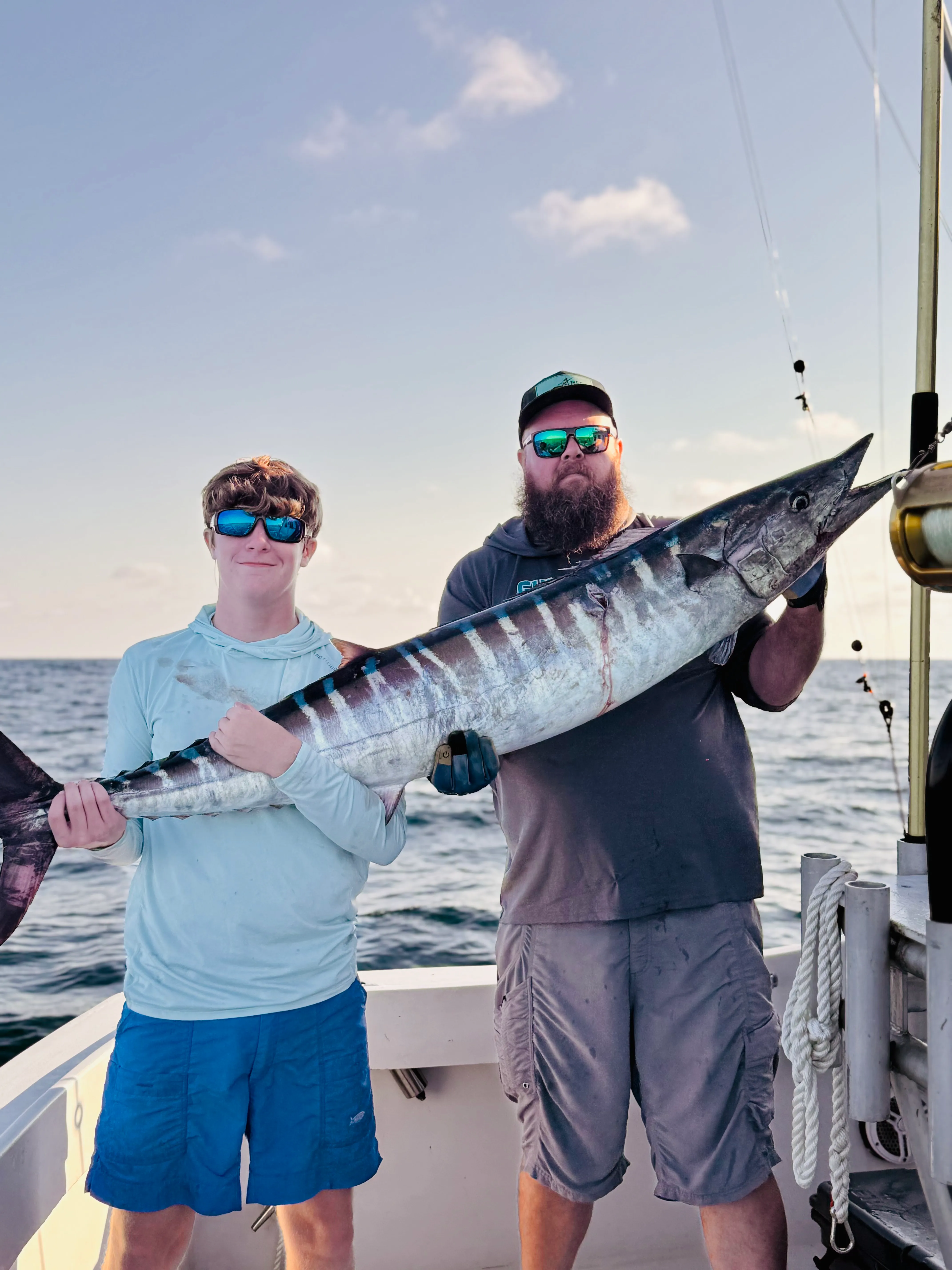 Two anglers holding an extremely long striped fish caught on Deep South Charters deep sea fishing trip Orange Beach Alabama